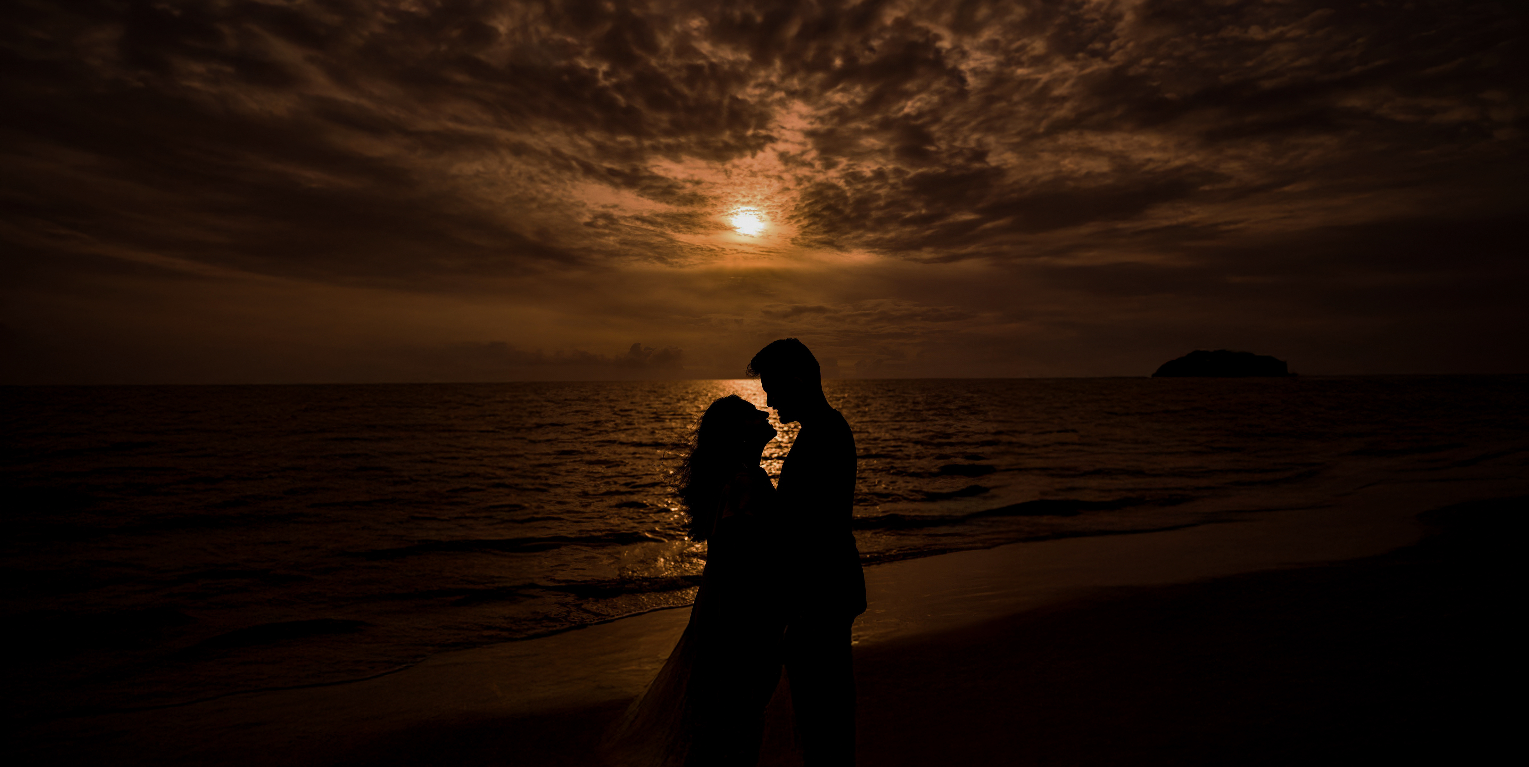 Sunset Romance - A beautiful couple silhouette against golden sunset
